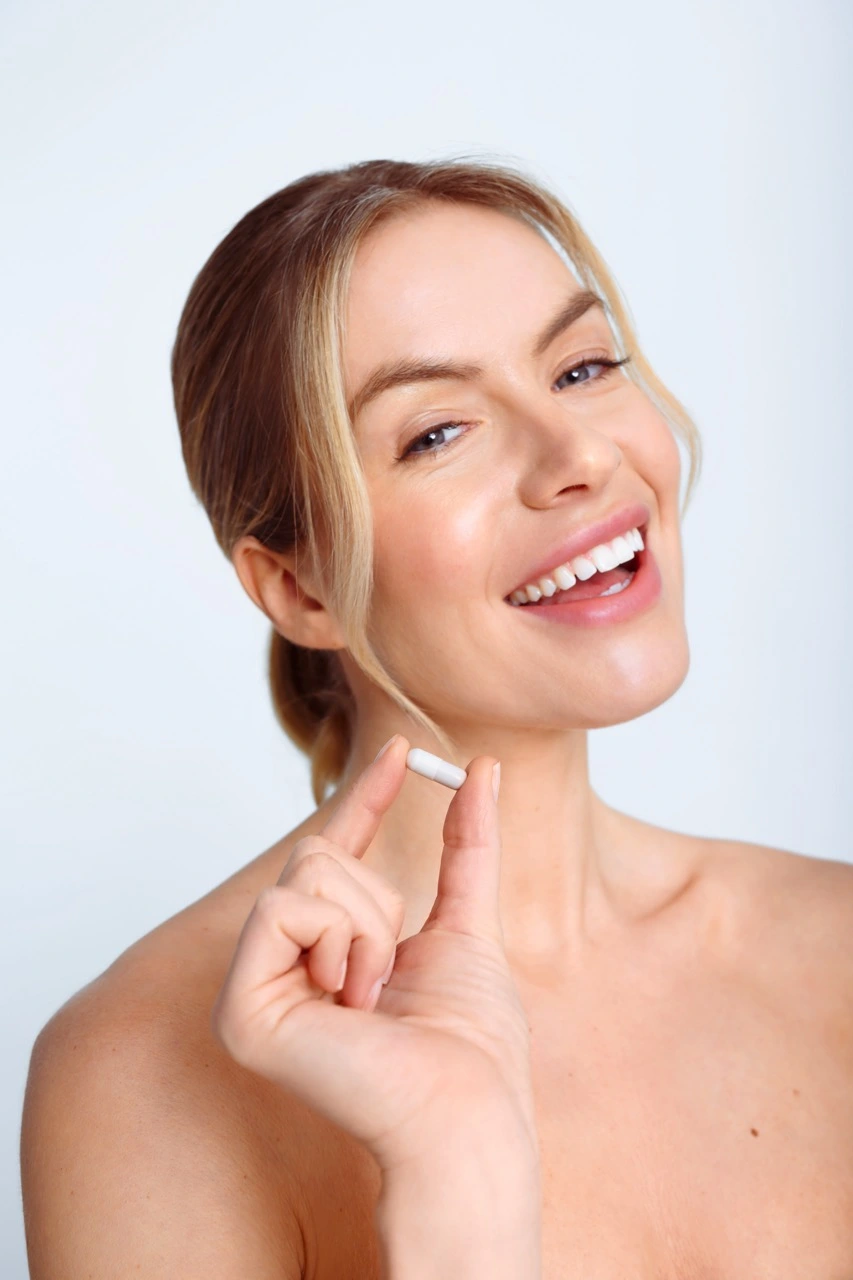 Model holding the day pill